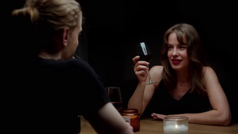 romantic couple enjoying wine and conversation at dinner