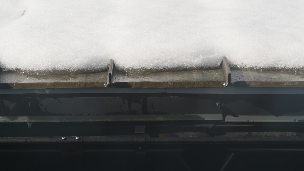 Timelapse of snow melting off of a roof due to rapidly rising Spring temperatures