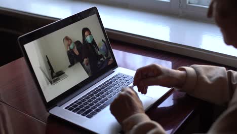 an-elderly-woman-looking-at-a-laptop-about-covid