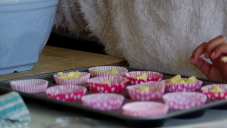 Girl-Putting-Mixture-Into-Cake-Cases-With-Father-Shot-On-R3D