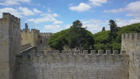 drone ascends above walls of sao jorge castle lisbon portugal