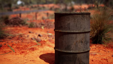 old-empty-rusted-barrel-on-sand