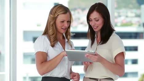 two females workers using an ebook