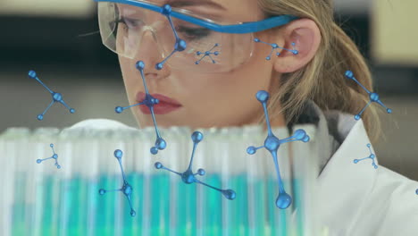 Animation-of-nucleotides,-female-caucasian-researcher-mixing-chemical-in-test-tubes-using-dropper