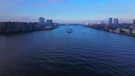 tanker ship coming through the north sea canal with amsterdam city in background