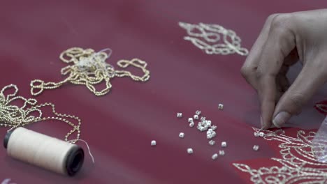 closeup shot of a sari being made by a seamstress, beautiful wedding dress for indian culture