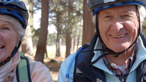 Close-up-shot-of-senior-couple-on-bikes-in-a-forest