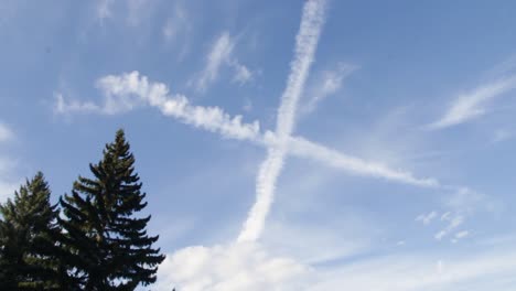 a tranquil breezy day with cross shape cloud flying across blue sky