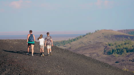 family hiking on volcanic terrain