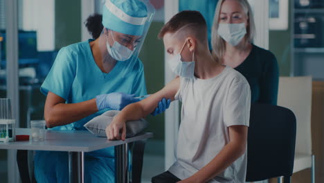 Young Boy Receiving a Vaccine Shot from a Medical Professional