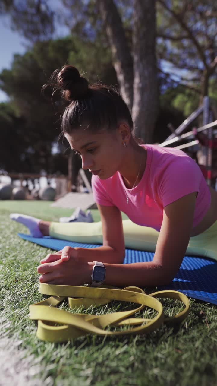 Woman doing splits and stretching outdoors