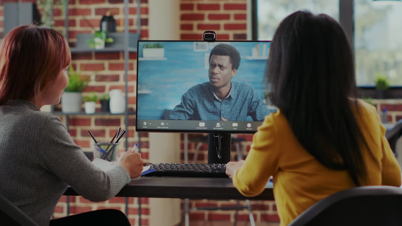 Asian women meeting with man on online video call for job interview