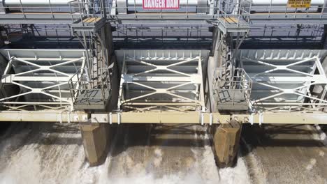 Water-flowing-through-water-dam-in-Michigan,-aerial-drone-view