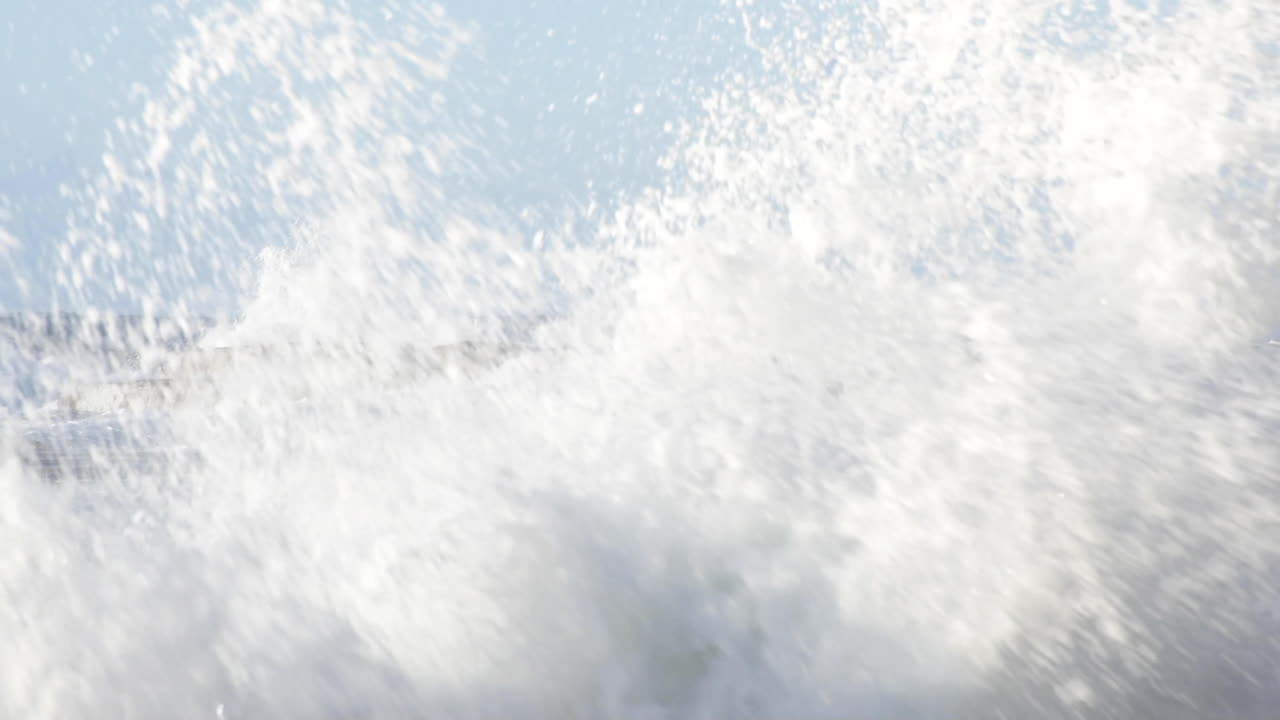 Large waves crashing onto horizontal bedded sedimentary ocean rocks front of screen slow-motion Turimetta Beach Sydney Australia
