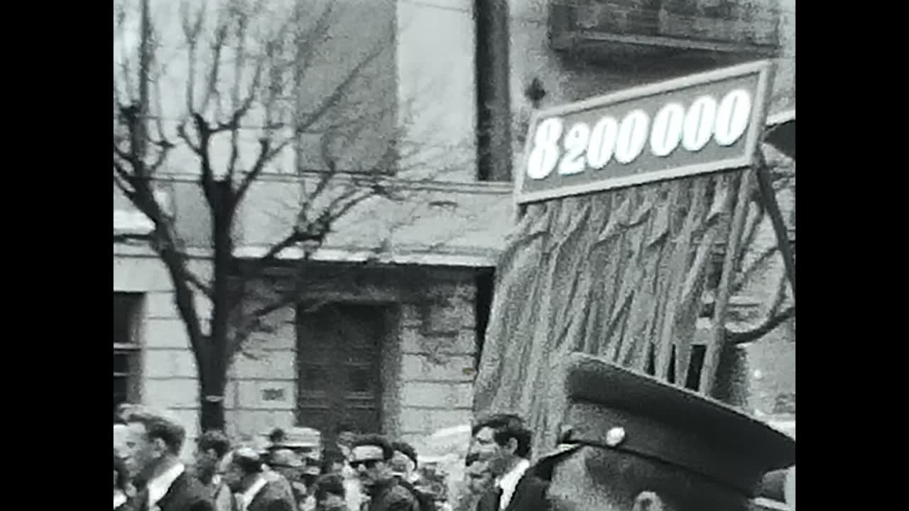 Crowd of People Walking Down a Street in the Soviet Union. CIRCA USSR 1970: A large group of Soviet people walking together on a street in the USSR.