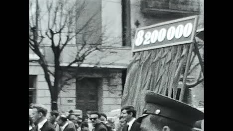 crowd of people walking down a street in the soviet union. circa ussr 1970: a large group of soviet people walking together on a street in the ussr.