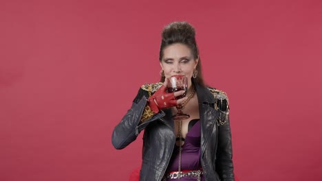 woman in 80s fashion drinking red wine
