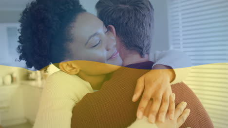una pareja abrazada en la cocina con una animación de la bandera de ucrania sobre su abrazo