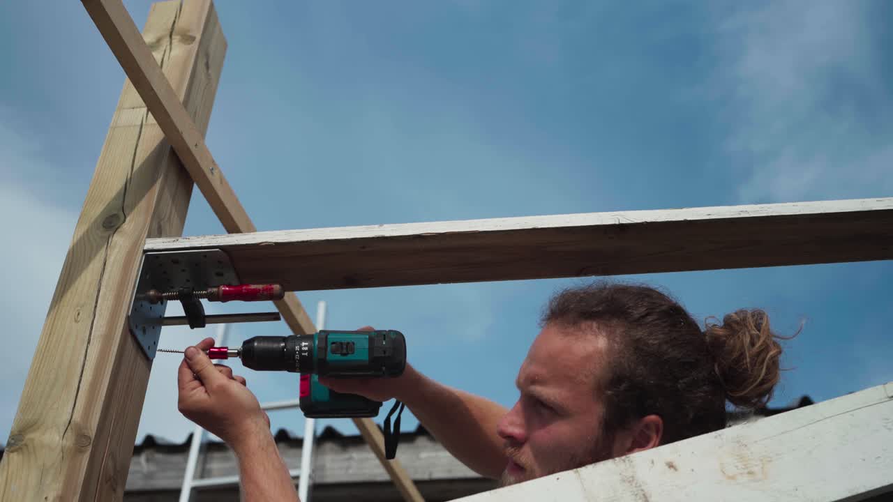 Caucasian Man Mounting Steel Corner Plate For Joining Wooden Frames