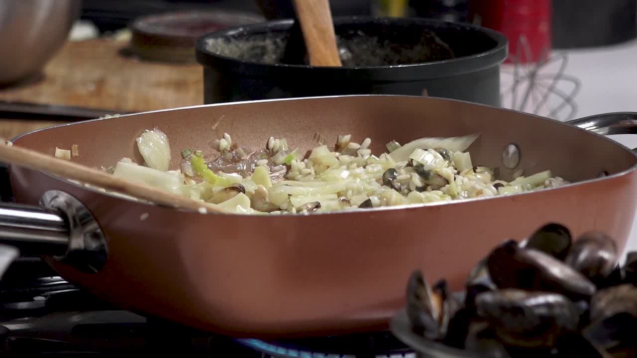 Chopping vegetables and stirring ingredients in a warm kitchen creates a delicious aroma. A focus on fresh ingredients highlights culinary skills and passion for cooking