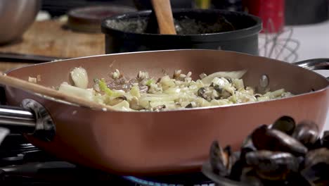 chopping vegetables and stirring ingredients in a warm kitchen creates a delicious aroma. a focus on fresh ingredients highlights culinary skills and passion for cooking