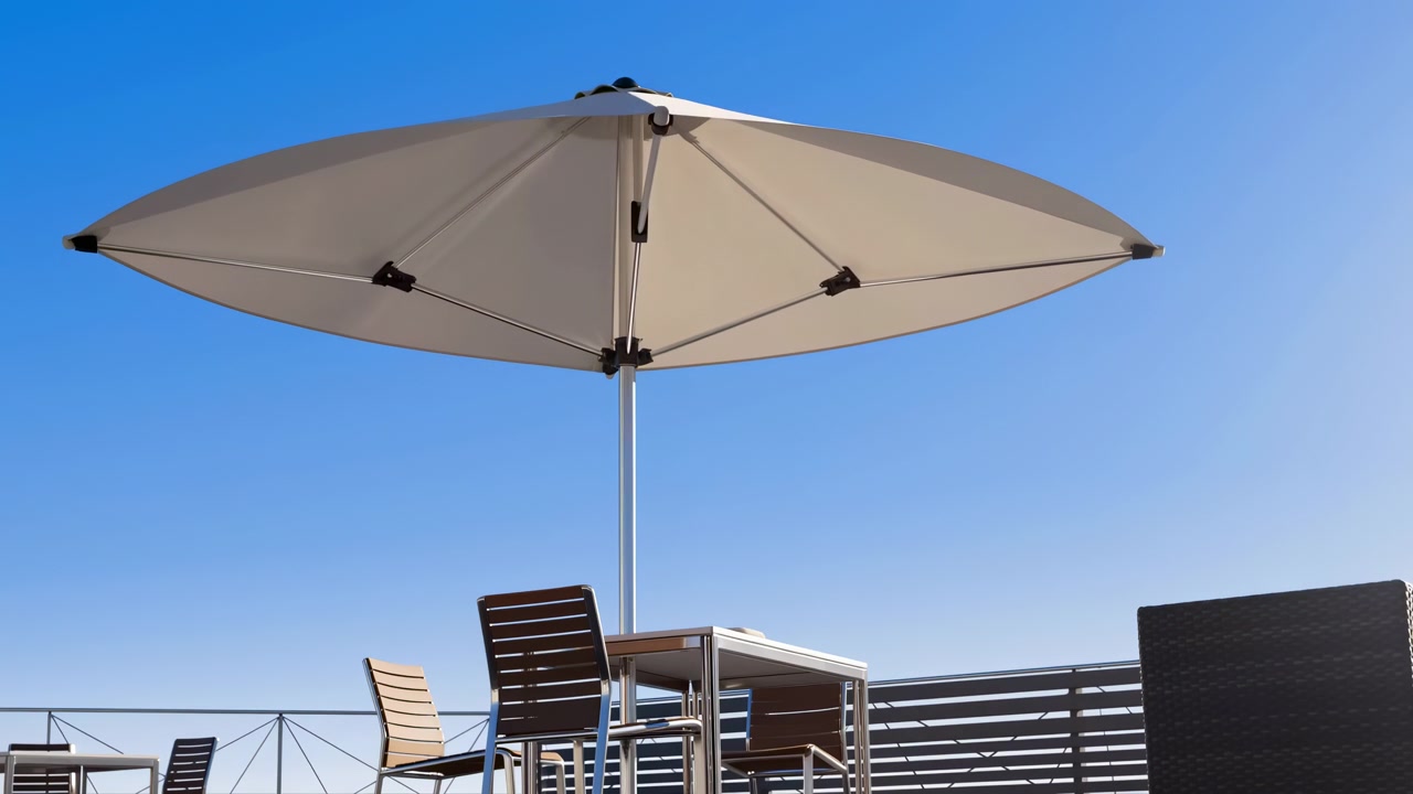 Open umbrella remains still on outdoor terrace as bright daylight illuminates canopy, chairs and railing, with wide viewpoint capturing clean lines, calm atmosphere and blue sky background.