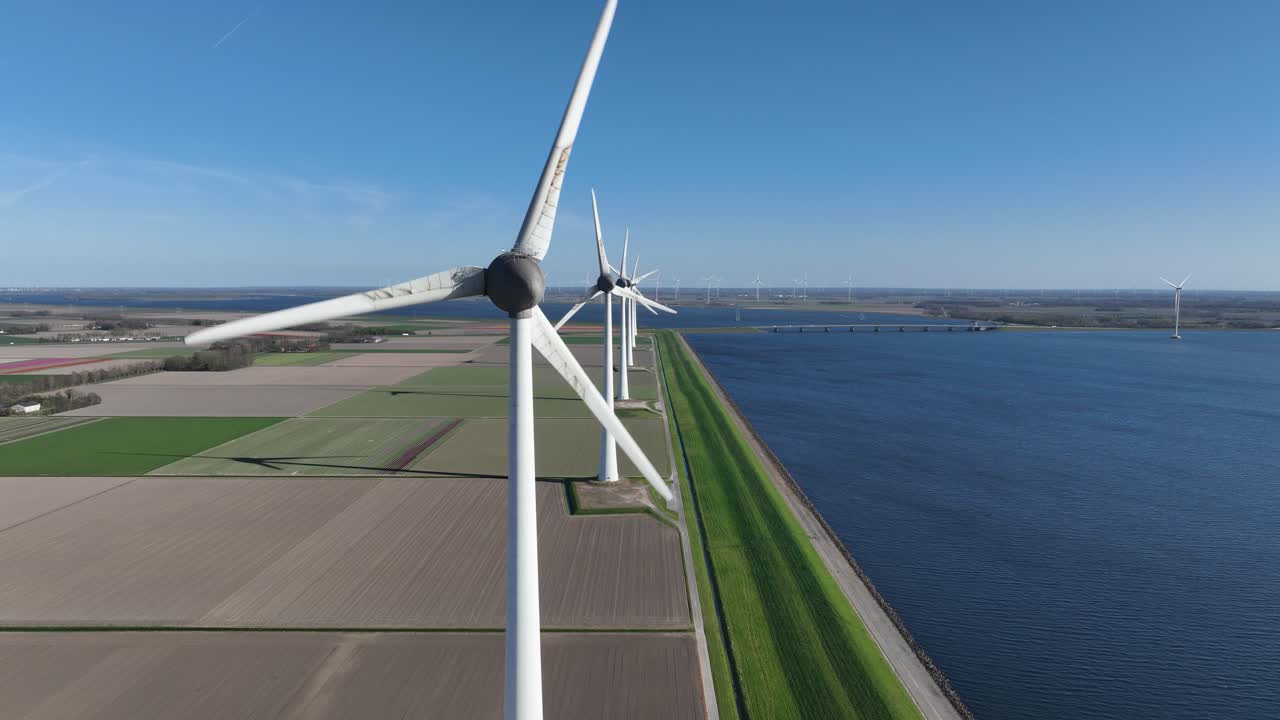 wind turbines along the water, aerial drone video, clean energy, green soltuion. Aerial drone video