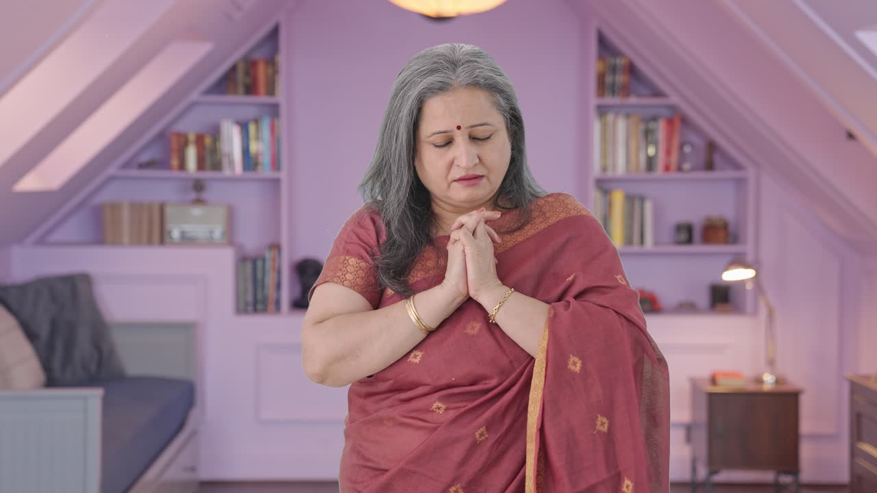 Religious Indian old woman praying