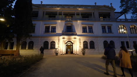 entrance to old luxury house in barcelona at night time, dolly forward