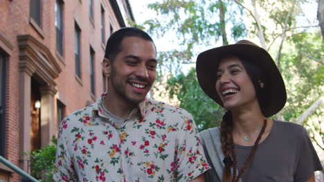 young couple walking along urban street in new york city