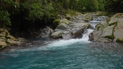 celestial-river-with-creek-between-rocks-in-the-rainforest-of-costa-rica-with-blue-water