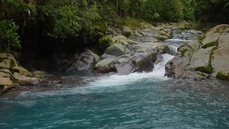 celestial river with creek between rocks in the rainforest of costa rica with blue water