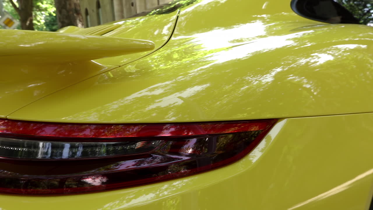 Close up of the stop lights of a yellow car on the street