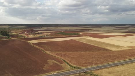 aerial dolly of the road cutting through expansive plains in extremadura, spain