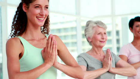 women at a yoga class in tree pose pose