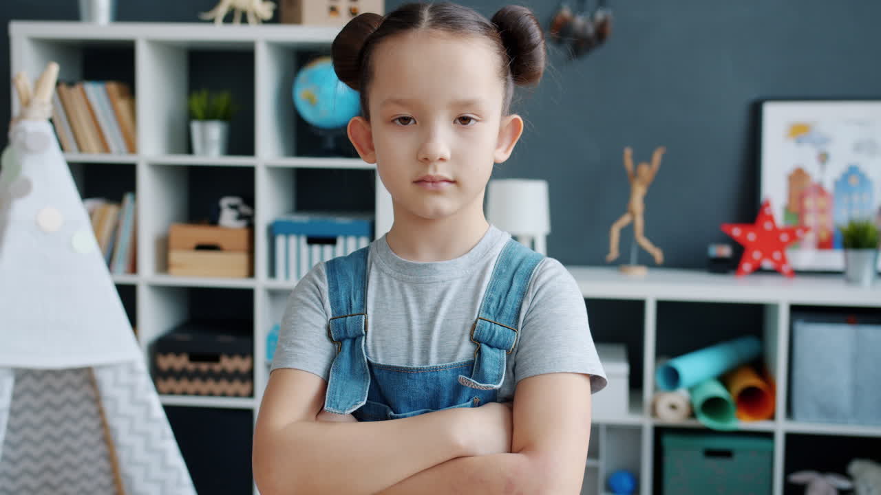 Girl with arms crossed in a playroom