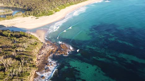 drone aerial view of bawley point sandy beach and reef in nature clear water ulladulla south coast nsw australia 4k