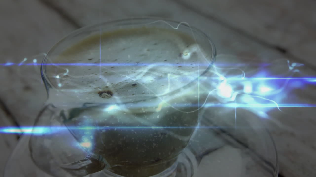Glass cup, saucer glowing with frothy coffee foam over wooden tabletop, featuring glitch effects