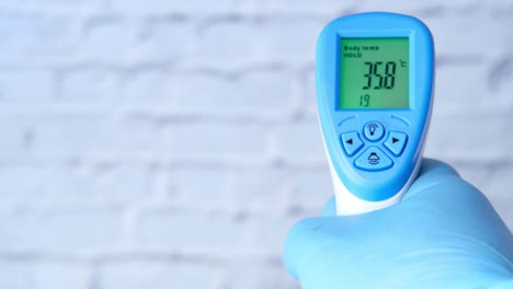 taking body temperature with a non-contact thermometer