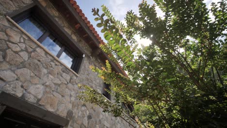 traveling of a residential facade house for vacional turism with rustical stone wall