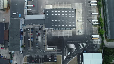 top-down aerial view of car parking space in riga city with cars and large trucks parked in formation, latvia