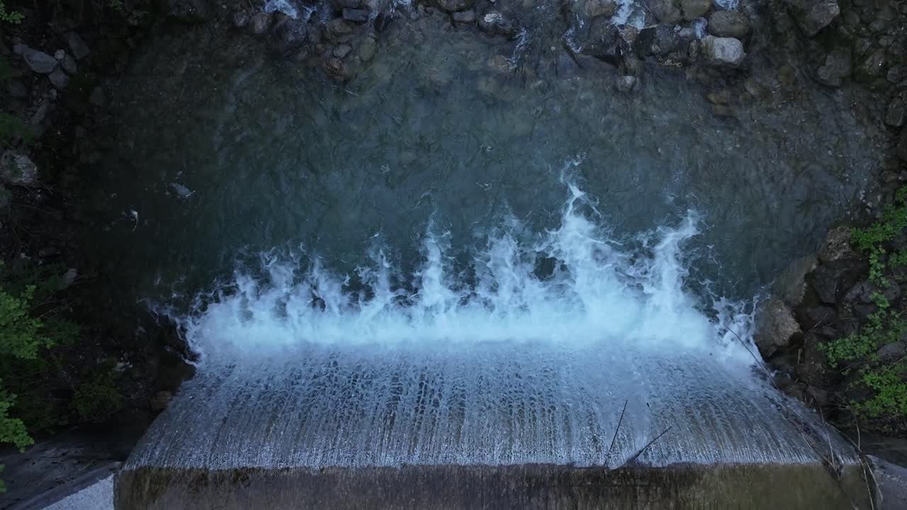 Aerial footage of an artificial waterfall dam in Weesen, Switzerland