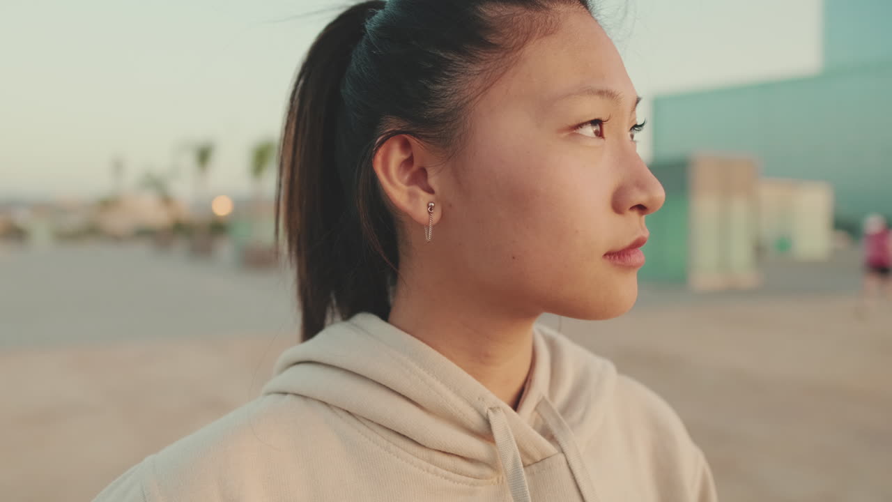 Retrato de una mujer con coleta y sudadera al aire libre
