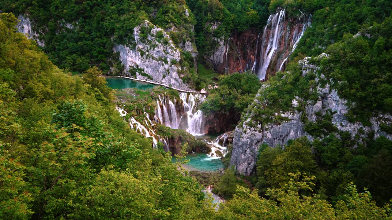 Turquoise waterfall pools, cliffs and forest landscape at Plitvice Lakes National Park, Croatia