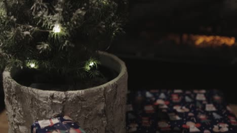 Wrapped-Christmas-Gifts-On-The-Floor-Beside-A-Cute-Christmas-Tree---Close-Up-Shot