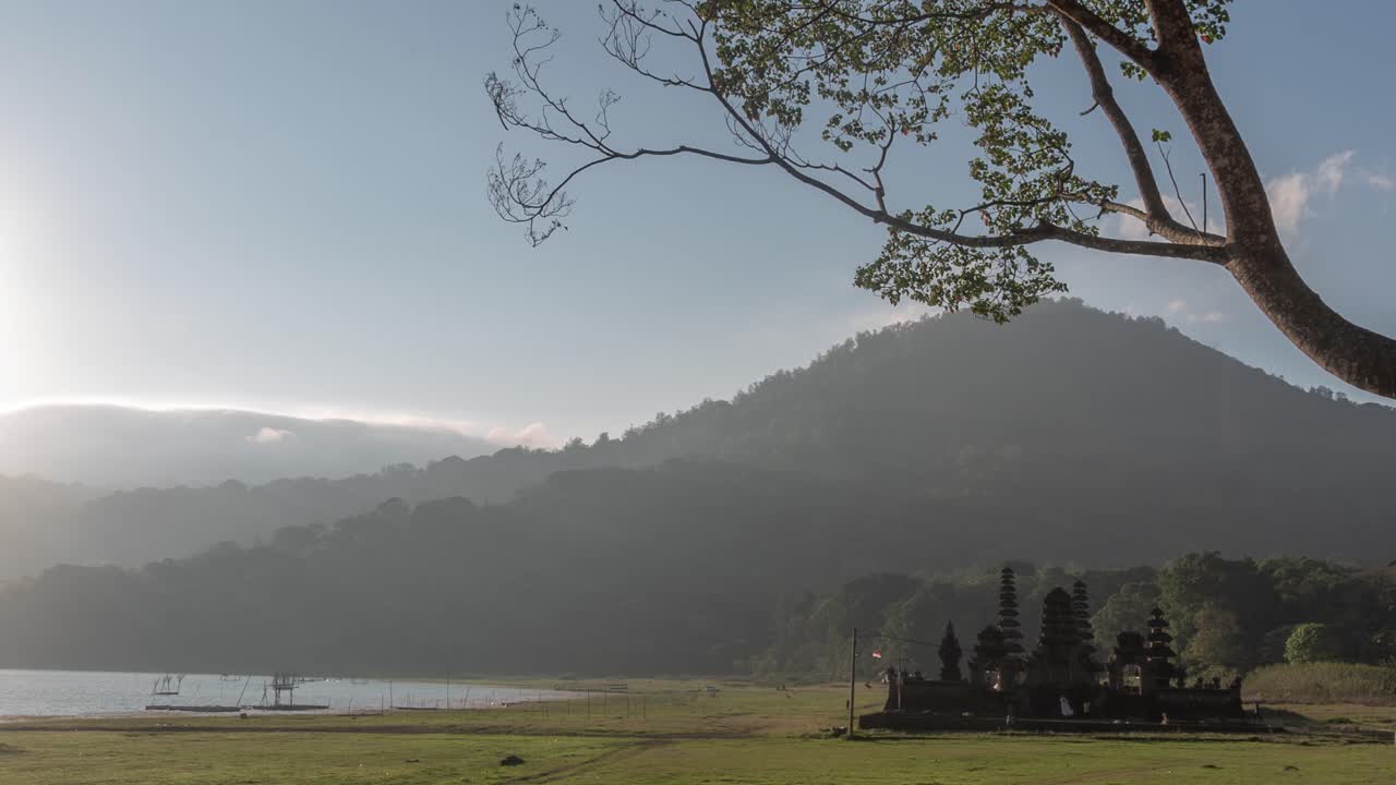 Sunrise over a Balinese Temple near a Volcano Lake