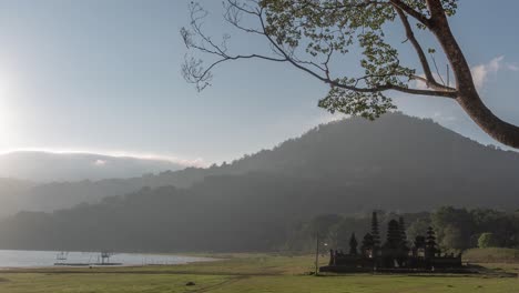 sunrise over a balinese temple near a volcano lake
