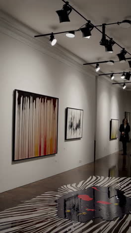 art gallery exhibition with abstract paintings