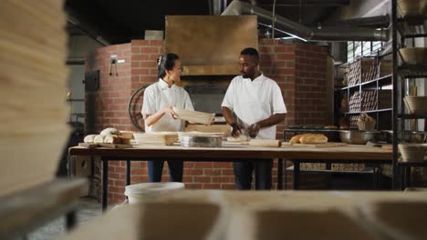 Animation-of-diverse-male-and-female-bakers-preparing-sourdough-for-bread