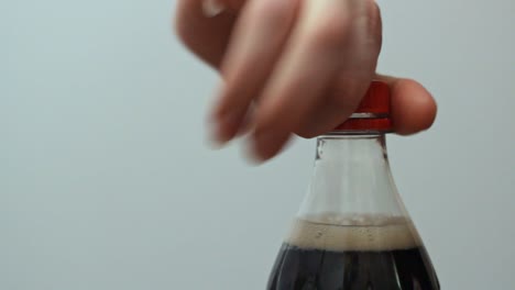 woman opening plastic delicious soda - cola bottle close up